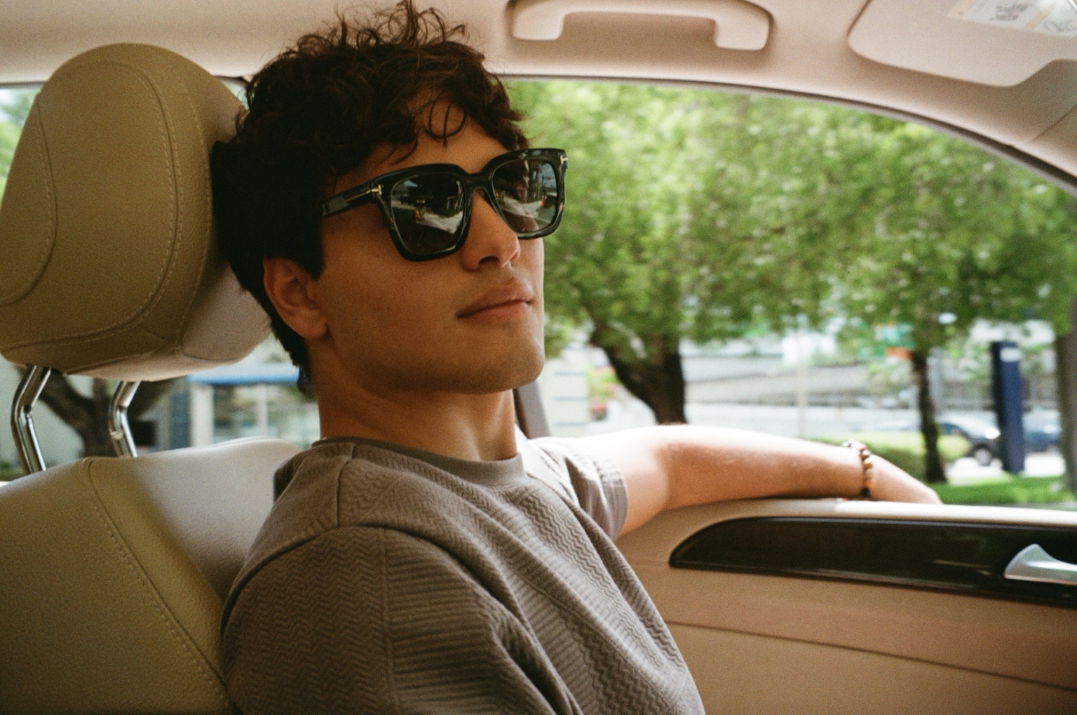 Portrait of a man wearing sunglasses in a car